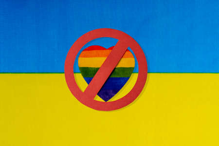 The Ukrainian flag and the ban on LGBT people. The red circle of the heart in the form of the Lgbt flag is crossed out.の写真素材