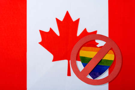 The Canadian flag and the LGBT ban. The red circle of the heart in the form of the Lgbt flag is crossed out.の写真素材