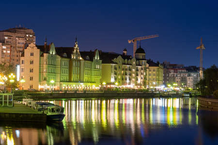 KALININGRAD, RUSSIA 05 June 2021 Fishing village in Kaliningrad in THE EVENING view of the Pregolya River with reflection in the water. The concept of travel and tourism.のeditorial素材