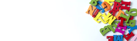 Wooden colored letters on a white background in various places. Copy Space.