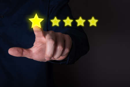 Business people click five stars on the visual screen in the Customer Service Concept concept. Rating of the best excellent services to meetの写真素材