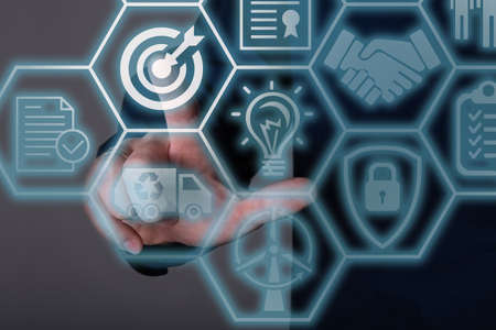 A businessman clicking on a target with a flat dart icon on a dark background. The concept of business successの写真素材