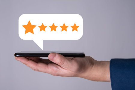The man uses a mobile phone, and puts 5 stars in the application rating. The concept of the best...