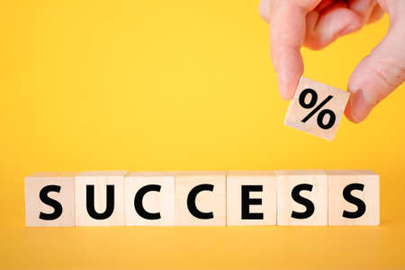 The success of the text on a yellow background of wooden cubes. business growth in teamwork.の写真素材