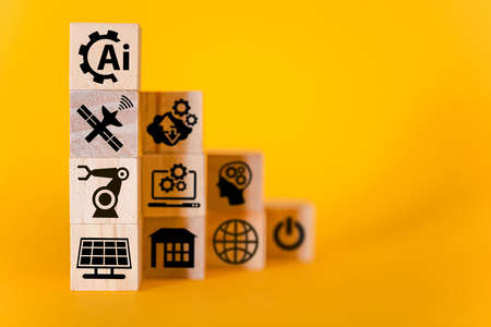 Artificial intelligence signs on wooden cubes, yellow background. The concept of artificial intelligence, the future.の写真素材