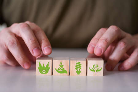 The concept of sustainable development or environmental protection. Environmental icons on wooden cubes.の写真素材