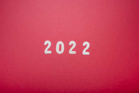 2022 on a red background, minimalism and copy space. The concept of the new year.の写真素材