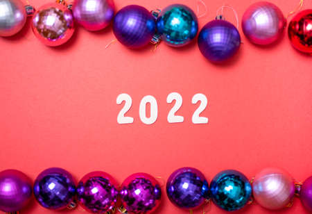 Christmas composition. Christmas red decorations, Christmas tree toys on a red background. Flat layout, top view, copy spaceの写真素材