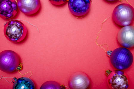 Christmas composition. Christmas red decorations, Christmas tree toys on a red background. Flat layout, top view, copy spaceの写真素材