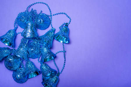 Bells on a lilac background with a view from above. The concept of the holiday.の写真素材