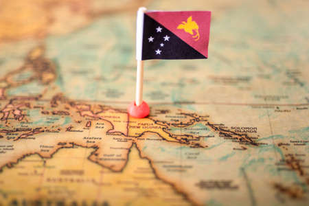 flag of Papua New Guinea, on the world map. The concept of travel and recreation in Papua New Guinea.の写真素材