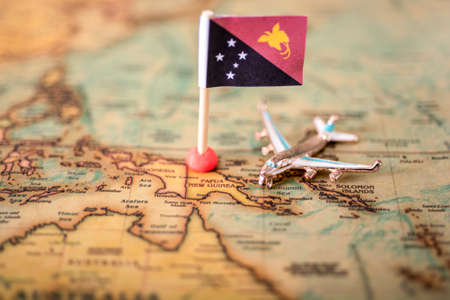 the flag of Papua New Guinea and the plane on the world map. The concept of travel and recreation in Papua New Guineaの写真素材