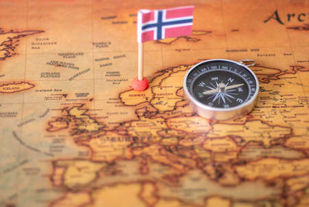 Norwegian flag and compass on the world map. The concept of travel and recreation in Norway.の写真素材