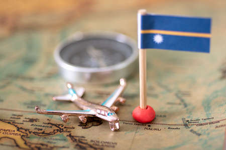 Nauru flag, airplane and compass on the world map. The concept of travel and recreation in Nauruの写真素材