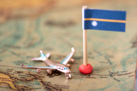 the flag of Nauru and the plane on the world map. The concept of travel and recreation in Nauruの写真素材