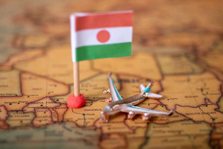 the flag of Niger and the plane on the world map. The concept of travel and recreation in Nigeriaの写真素材