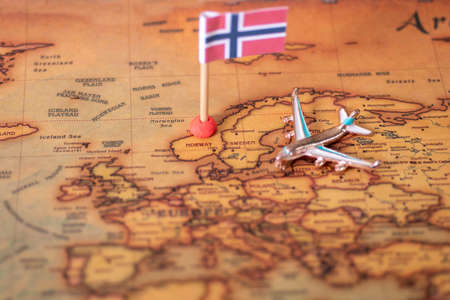 the flag of Norway and the plane on the world map. The concept of travel and recreation in Norway.の写真素材