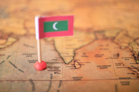 Maldives flag on the world map. The concept of travel and tourism.の写真素材