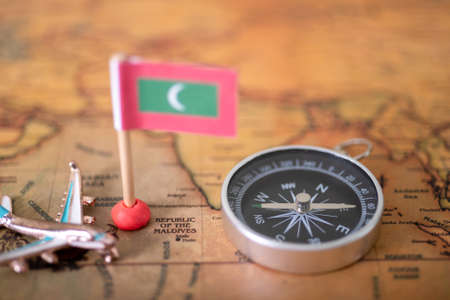 Maldives flag, airplane and compass world map. The concept of travel and tourism.の写真素材