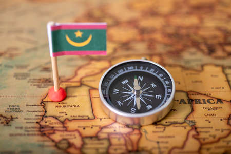 Flag of Mauritania and compass on the world map. The concept of travel and tourism.の写真素材
