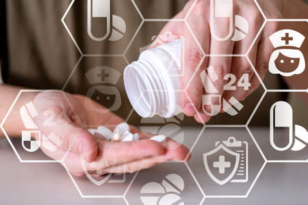 Medical pills or capsules in a man's hand. The concept of pill treatment.の写真素材