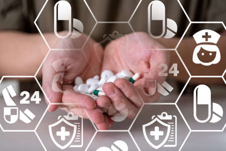 Medical pills or capsules in a man's hand. The concept of pill treatment.の写真素材