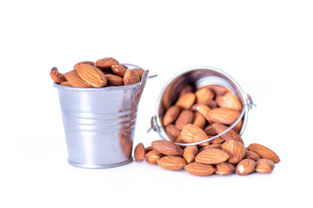 almonds in a bucket on a white background. The concept of healthy food.の写真素材