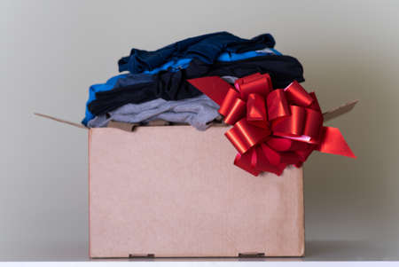 A large brown cardboard box filled with things. The concept of moving or donating.の写真素材