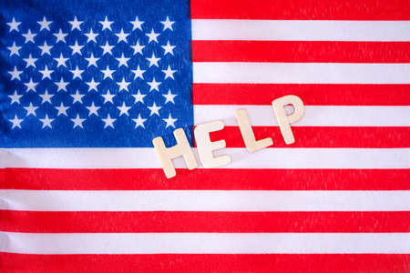 The flag of the United States of America with the inscription help. The concept of help from the United States of America.の写真素材