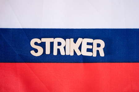 The flag of Russia and the inscription of the striker. The concept of Russian aggression.の写真素材
