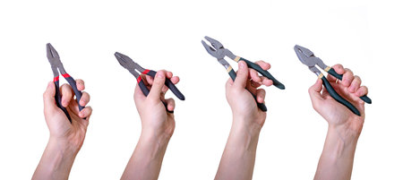 Pliers in the hands of a man on a white background. Labor Day on the first of May. Collage of men's hands with pliers.の写真素材