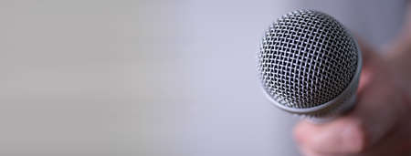 A man holds a microphone in his hand with room to copy. World Press Freedom Day.の写真素材