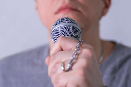 A man speaks into a microphone in close-up. World Press Freedom Day.の写真素材