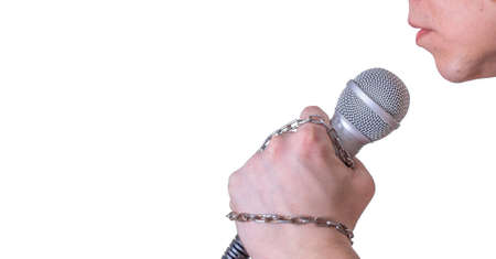 A man speaks into a microphone in close-up, against a white background. World Press Freedom Day.の写真素材
