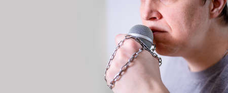 A man speaks into a microphone in close-up. World Press Freedom Day.の写真素材