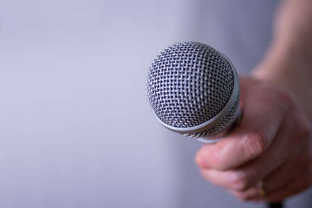 A man holds a microphone in his hand with room to copy. World Press Freedom Day.の写真素材