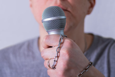 A man speaks into a microphone in close-up. World Press Freedom Day.の写真素材