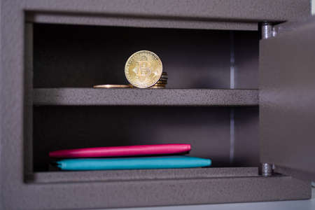Small residential vault with physical bitcoin. Bitcoin in a safe deposit box.の写真素材