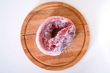 Frozen pork meat on a cutting board. top view. Frozen pork loin, eating concept.の写真素材