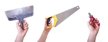Hands holding hand tools, insulated on white background. Tool saw, wire cutters and spatula.の写真素材