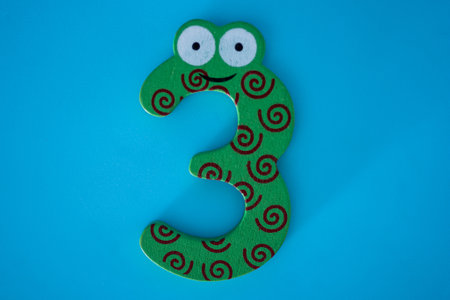 The green number three on a blue background. Isolated blue background.の写真素材