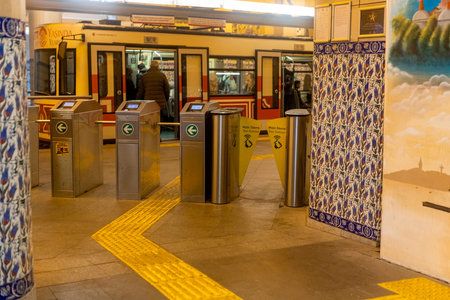 Entrance through the turnstile at the subway in Istanbul, Turkey January 2023. Karakoy area,...