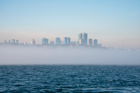 Fog over the Bosphorus Strait, the backdrop to high-rise buildings. The concept of travel and tourism.の写真素材