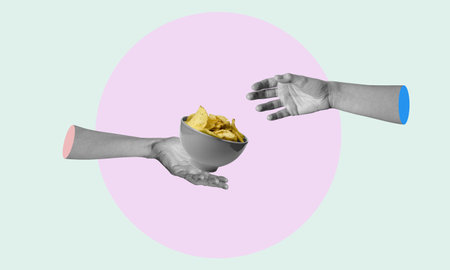 Creative art collage, the hand holding a plate of chips passes to the other hand. The concept of junk food.の写真素材