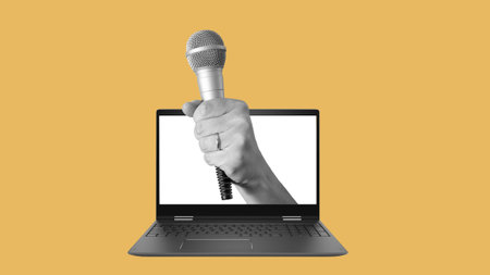 Collage art, the hand with a microphone sticking out of the laptop on a light background. Yellow press from a laptop, daily news.の写真素材