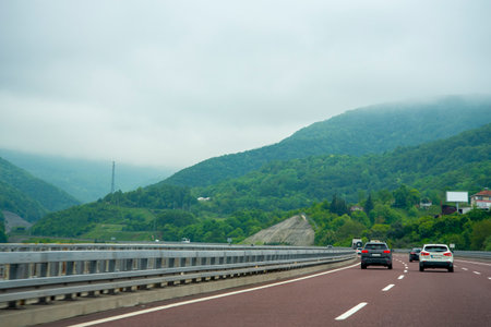 The car drives along a beautiful mountain road. The concept of travel and tourism.の写真素材