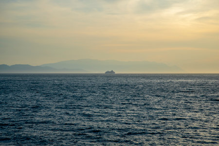 Cruise ship sailing into the sunset. The concept of tourism and travel.の素材 [FY310204267952]