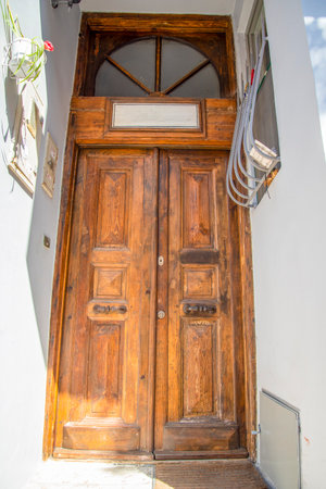The front door is brown wood, in the old style. The concept of travel and tourism.の写真素材