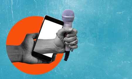Art collage, modern art collage, the hand with a microphone from a phone, on a blue background Concept of an interview or news with room for advertising.の写真素材