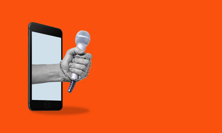 Art collage, modern art collage, hand with a microphone from a phone, on a red background Concept of an interview or news with room for advertising.の写真素材